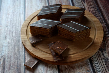 Chocolate cake on a wooden background. Chocolate cake on a wooden background. Homemade cakes, dessert