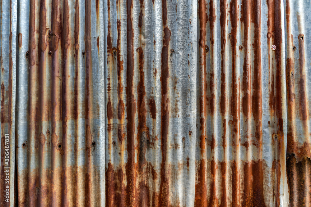 Wall mural rusted galvanized iron plate, red stain on old metal sheet wall texture.