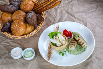 chicken breast fingers filled with herbs sauce, served with rice and bread