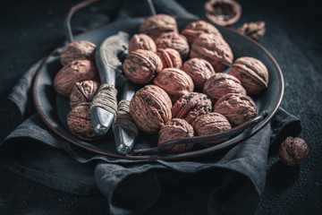 Fresh walnuts with with old metal nutcracker