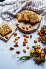Obraz na płótnie Canvas granola squares served with almond, walnut and pistachio