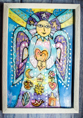 Fototapeta premium Angel with heart in hands on landscape backgroundPainting on glass.