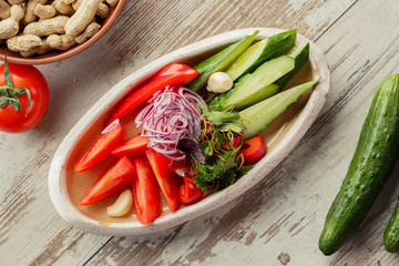 Caucasian Eastern European cuisine. Georgian restaurant salad. The photograph lay flat on the table.