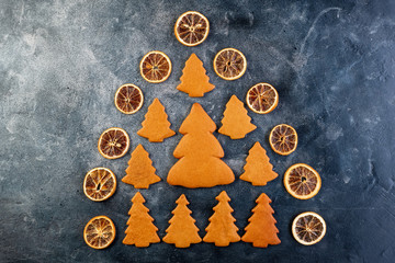 Collection of various gingerbread christmas trees with dried orange slices