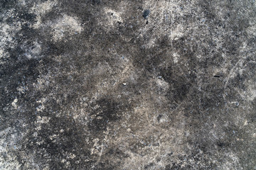 Fototapeta na wymiar Grunge gray concrete floor as a texture background wallpaper. Ground cement abstract. Old dirty floor with black stains from mold on concrete surface.