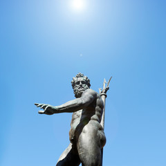 The antique statue of Neptune, the god of water and the sea in roman mythology and religion, an famous monument of the italian Renaissance, in Bologna, Italy © Davide Zanin