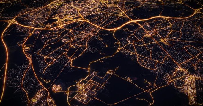 Aerial night view of city of Manchester, UK, England. Traffic and street light glowing. Camera flying above space filming cinematic straight and tilting down. 3d animation rendering.
