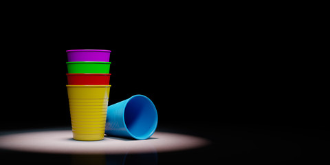 Pile of Plastic Cups Spotlighted on Black Background