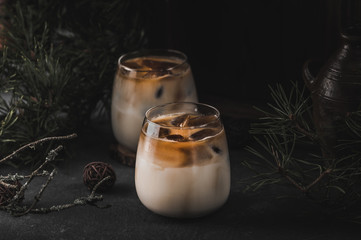 Iced coffee cocktail with milk on dark background