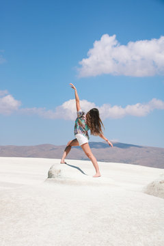 young woman back in dance position   on tufa  white rock