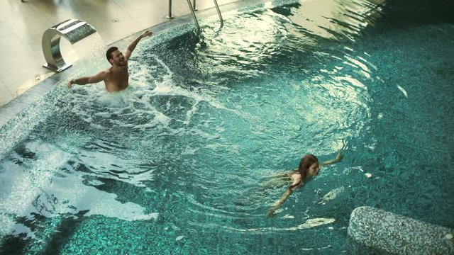 Above view cheerful couple enjoying hydrotherapy at wellness resort.