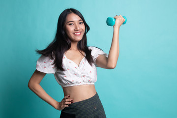 Healthy Asian woman with dumbbells.