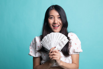 Portrait of  young asian woman  showing bunch of money banknotes.