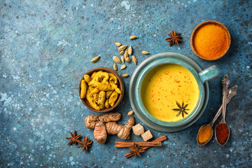 Healthy drink of golden turmeric milk with spices