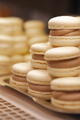 Tasty french macaroons on shopwindow in a bakery and coffee shop.
