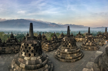 Borobudur sacred temple, stuning ancient temple with black stone bells (stupa) in yogyakarta, java, indonesia