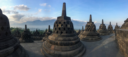 Panorama in Borobudur sacred temple, stunning ancient temple with black stone bells (stupa) in yogyakarta, Java, Indonesia.