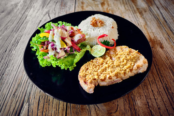 Grilled tuna steak with rice and vegetables.