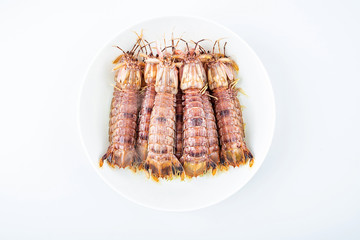 Delicious steamed crusty shrimp on a plate on white background