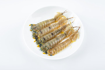 Fresh pip shrimp on a plate on white background