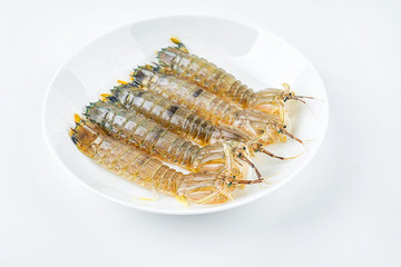 Fresh pip shrimp on a plate on white background