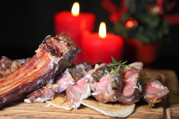 Rib eye steak on the New Year's table. Steak rib eye roast on a wooden board with sauce and salt. Beef steak on wooden plate.