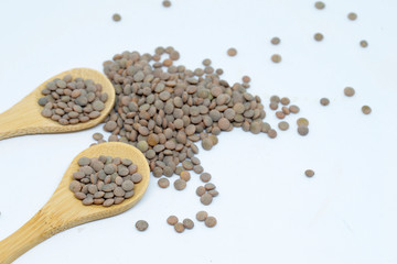 Lentils with white background and wooden spoon