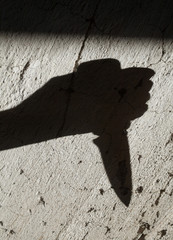 Shadow of the hand holding a knife