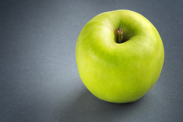 Green apple on a dark background