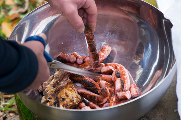 man cutting sausages and barbecue meat