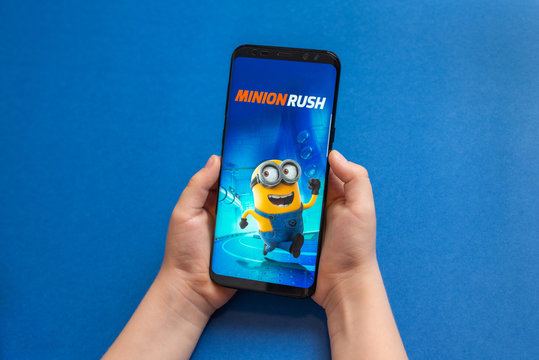 Sarajevo, Bosnia and Herzegovina - November 30, 2019: Minion Rush mobile action video game on modern smart phone in kid hands close-up
