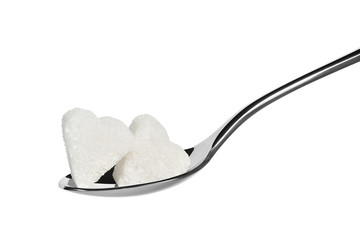 two pieces of sugar on a teaspoon in the shape of a heart isolated on white.Entire image in sharpness.