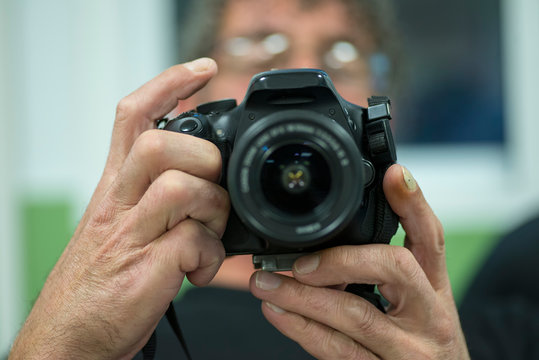 man using reflex photo camera
