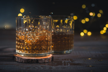 Glass of scotch whiskey on dark background