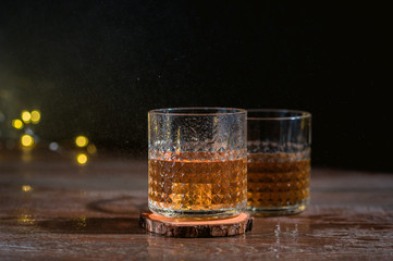 Glass of scotch whiskey on dark background