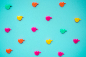 multicolored plastic hearts on a blue background