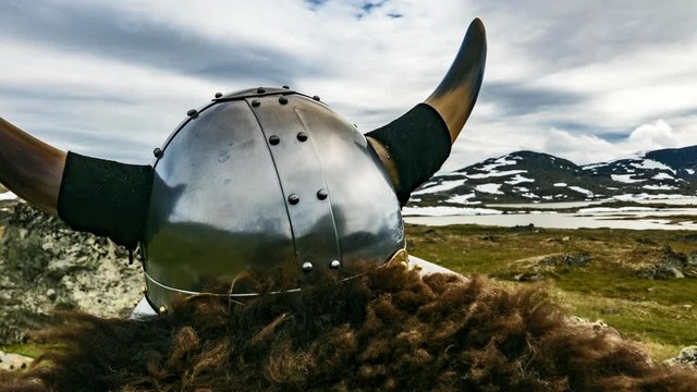 Viking helmet on nature in Norway. Clouds moving over mountains landscape. Time lapse