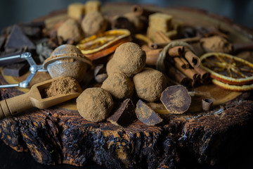 Craft chocolate truffles on wooden surface