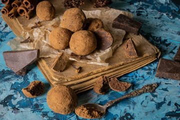Fototapeta na wymiar Craft chocolate truffles on turquoise background