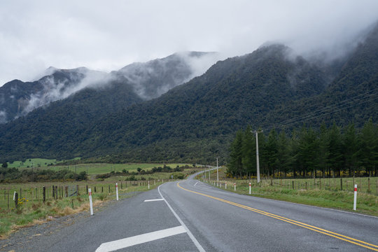 Scenic route of Arthur's Pass in New Zealand during misty morning.