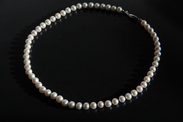 A pearl necklace for woman isolated on black background