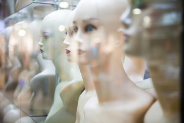 Naked female mannequins in the shop window.