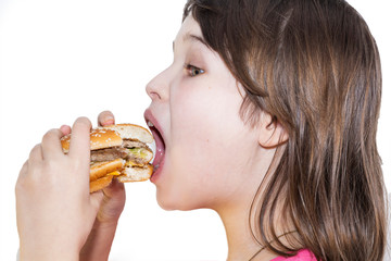 portrait of a beautiful girl, teenager and schoolgirl, holding a hamburger on a white background.