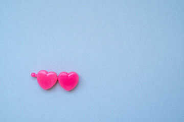 multicolored plastic hearts on a blue background