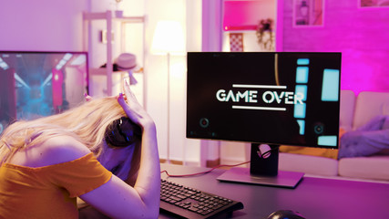 Blonde girl upset she lost on a shooter online game © DC Studio