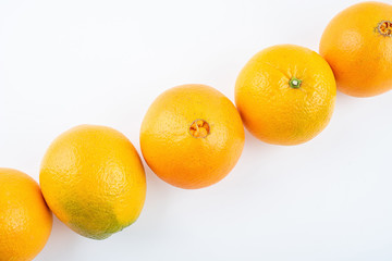 Row of fresh Gannan navel oranges on white background