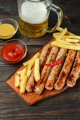 Grilled lunch hot sausages with French fries, ketchup and mustard ,  sausages pork beef