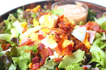 Healthy Salad with Dressing in Wood Bowl
