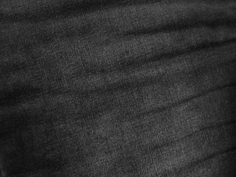 Black Fabric Grunge Texture. Dark Gray Denim Texture. Faded Worn Jeans Close-up. Black Old Jeans Background. Gray Abstract Background.