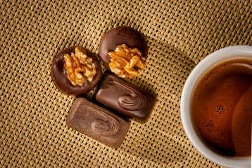 Cup of coffee and delicious chocolates